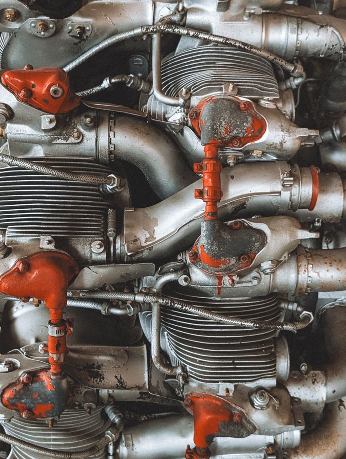 Detailed view of complex metal machinery parts with red accents, showcasing engineering detail.